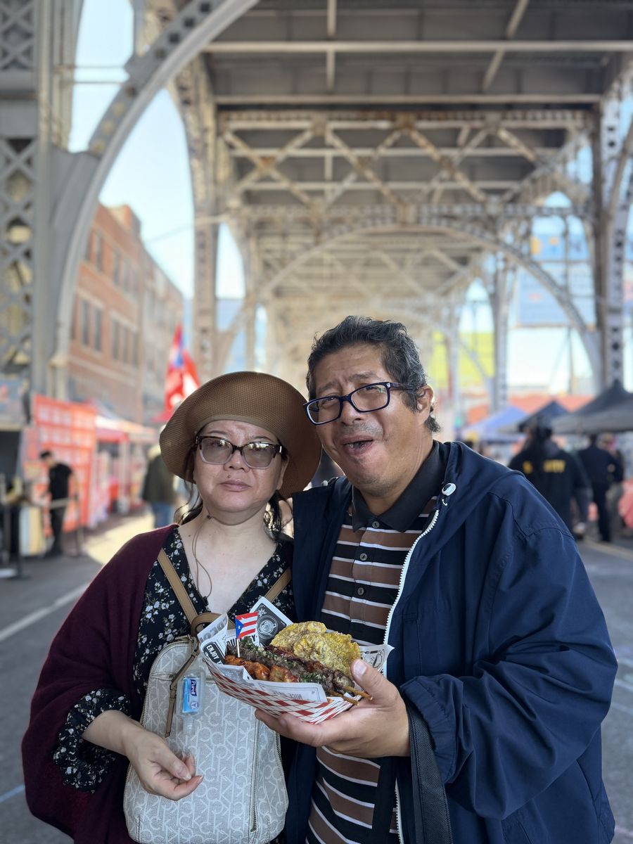 A couple sharing a plate under the viaduct